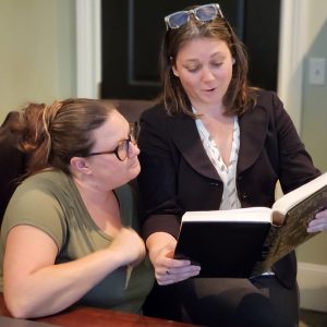 digital-marketing-experts-lead-generators-south-carolina Cynthia and Tayla looking at a book.