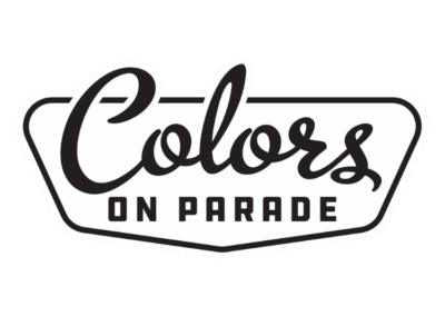 “Colors On Parade” logo in stylized black text inside a vintage-style outlined badge shape.